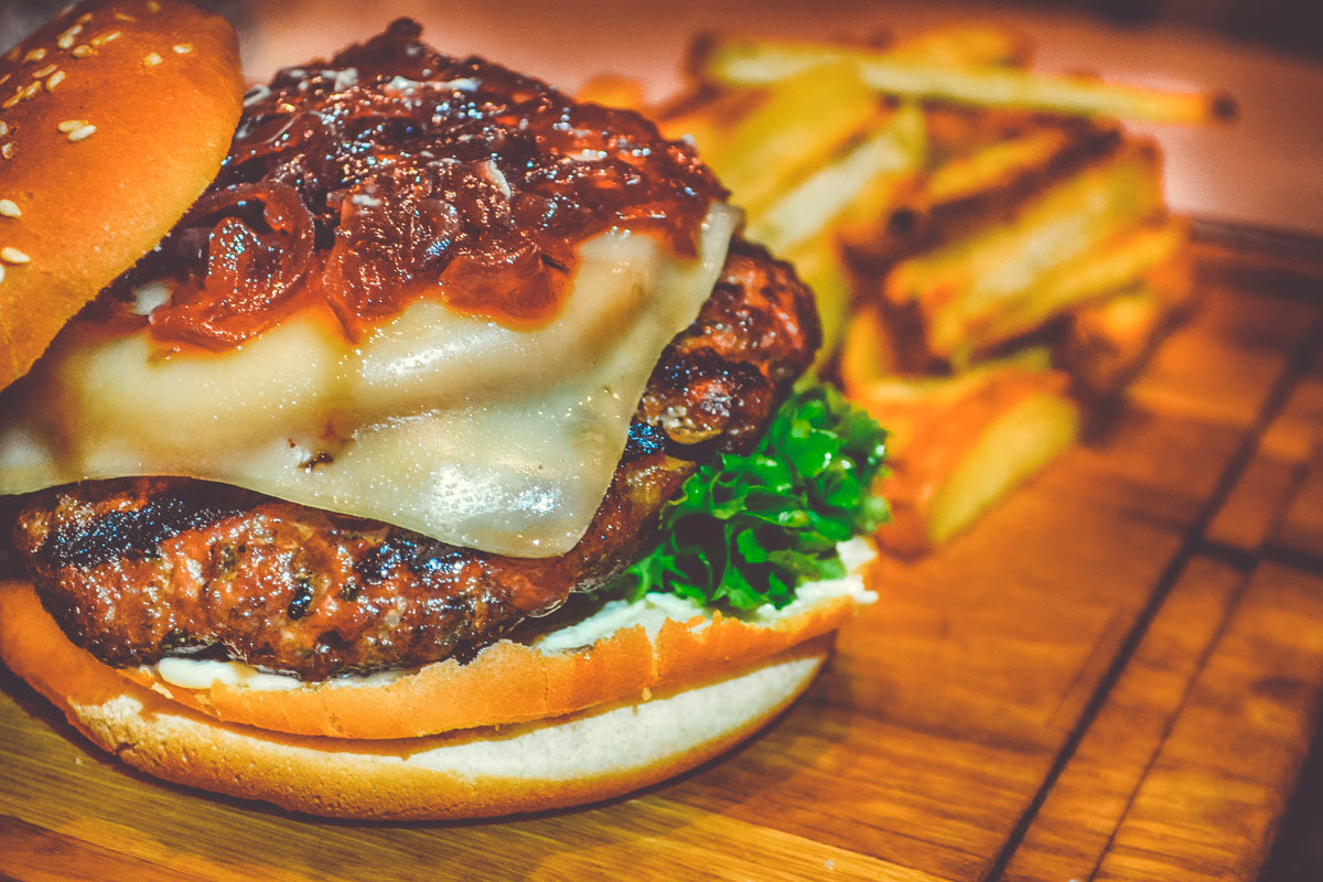 selective-focus-of-ham-burger-on-wooden-surface-photo-750075